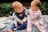 Adorable boy-girl twins in matching outfits