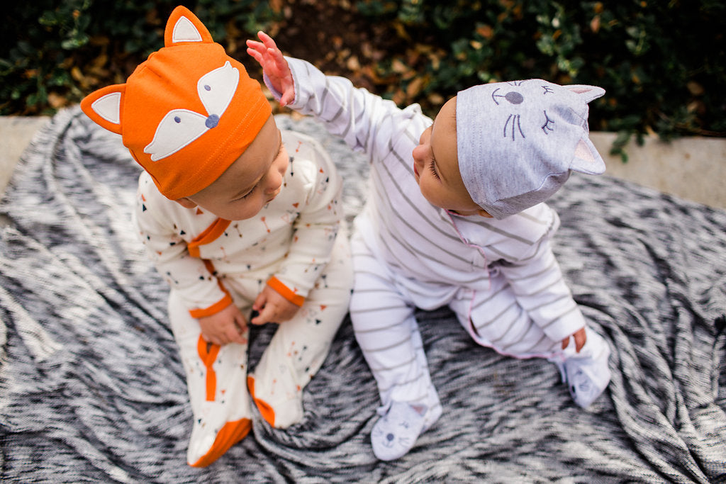 Boy-Girl Twins in matching cotton footies and hat